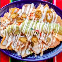 Nachos · A generous portion of chips, topped with our famous refried beans, melted jack cheese, pico ...