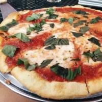 Margherita Pizza · Roma tomato sauce, Buffalo mozzarella, basil and extra virgin olive oil.
