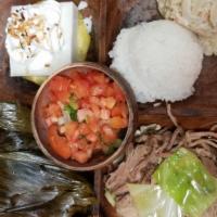 Luau Plate · A classic Hawaiian dish of tender pulled pork and taro leaves wrapped in ti leaves and then ...