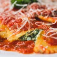Spinach Ravioli · Ravioli stuffed with spinach and ricotta in a tomato sauce with basil.
