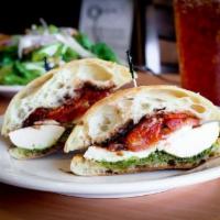 The Mozz Sandwich · Mozzarella, roasted herbed tomato and fresh tomatoes, walnut pesto and balsamic reduction.
