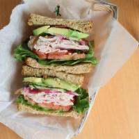 The Club · Smoked turkey, avocado, bacon, tomato, cucumber, lettuce, pickled red onion on toasted wheat...