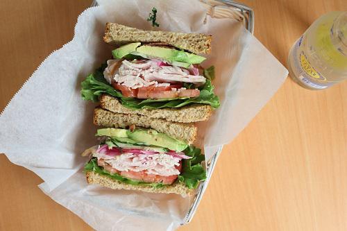 The Club · Smoked turkey, avocado, bacon, tomato, cucumber, lettuce, pickled red onion on toasted wheat bread.