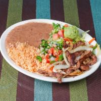 Al Carbon Taco Plate · Fajita beef with salsa verde and cilantro. 3 Soft tacos corn or flour. Served with rice and ...