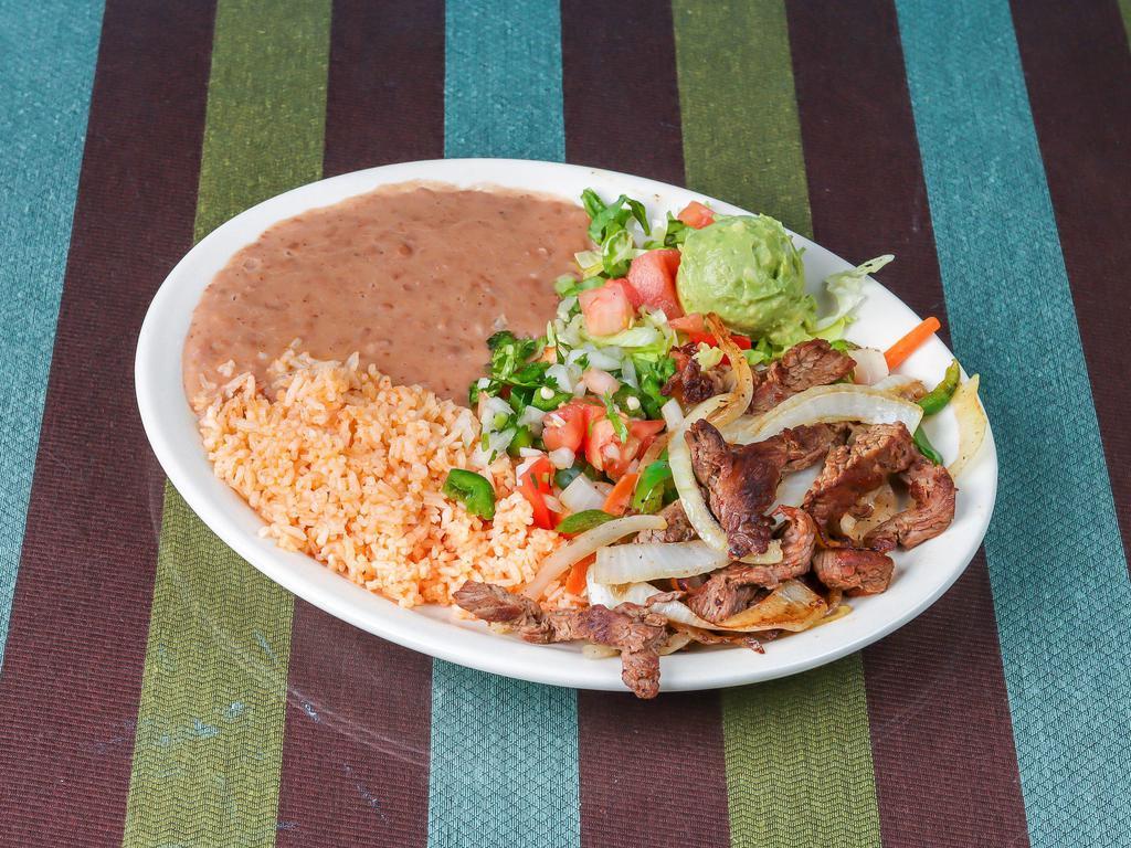 Al Carbon Taco Plate · Fajita beef with salsa verde and cilantro. 3 Soft tacos corn or flour. Served with rice and beans.
