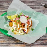 Fried Fish Taco · Corn tortillas, red and green cabbage, sour cream, and fresh salsa.