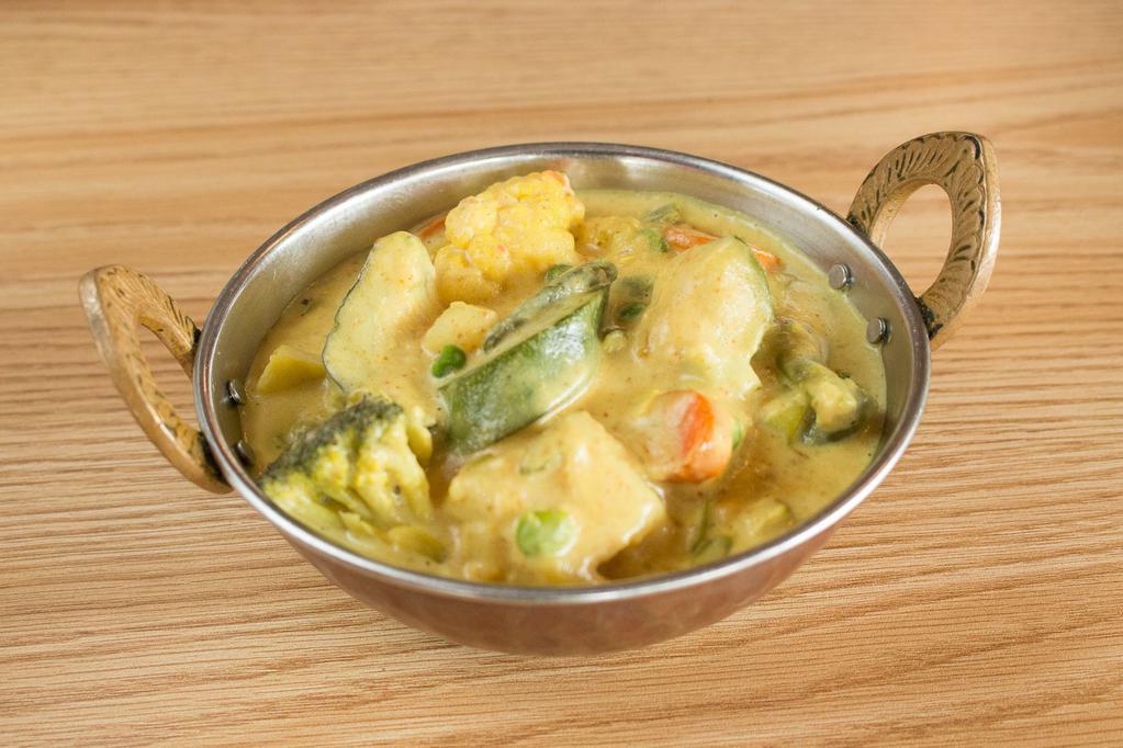 Navratan Korma · Mixed vegetable cooked in a light yellow cream sauce with Chef’s special selection of herbs.