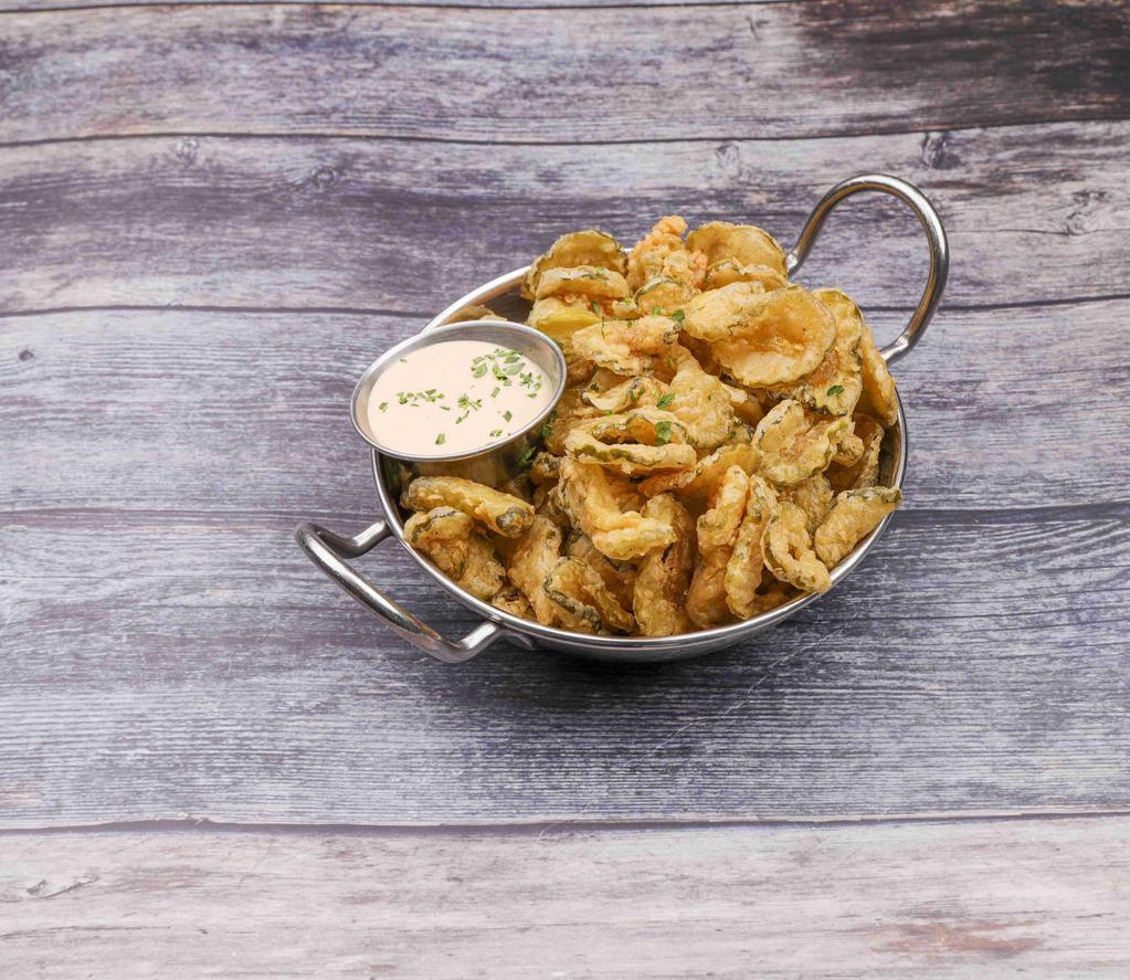 Bayou Pickle Chips · Thin sliced pickle chips soaked in buttermilk, lightly breaded, flash fried crispy and served with chipotle ranch for some real dipping fun.