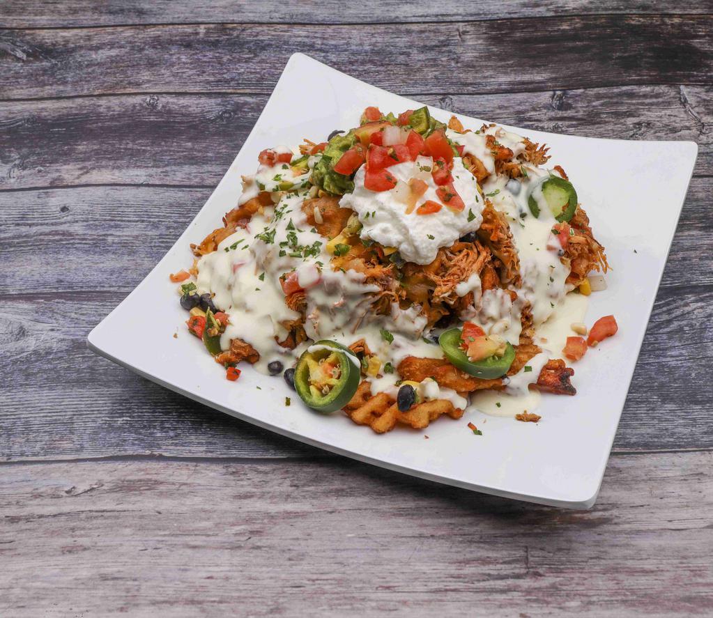 Waffle Fry Nachos · Smothered with white cheddar sauce and shredded cheeses, topped with house smoked chicken and finished with black bean corn salsa, fresh jalapenos, pico, guacamole and sour cream. *Can substitute different meat