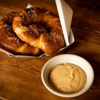 Fondue Pretzel · Hot buttered and salted Bavarian pretzel sticks. Served with Aletruism beer cheese fondue.
