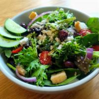 Greek Salad · Spring greens topped with fresh cucumber, tomato, Kalamata olives, feta cheese, and house-ma...