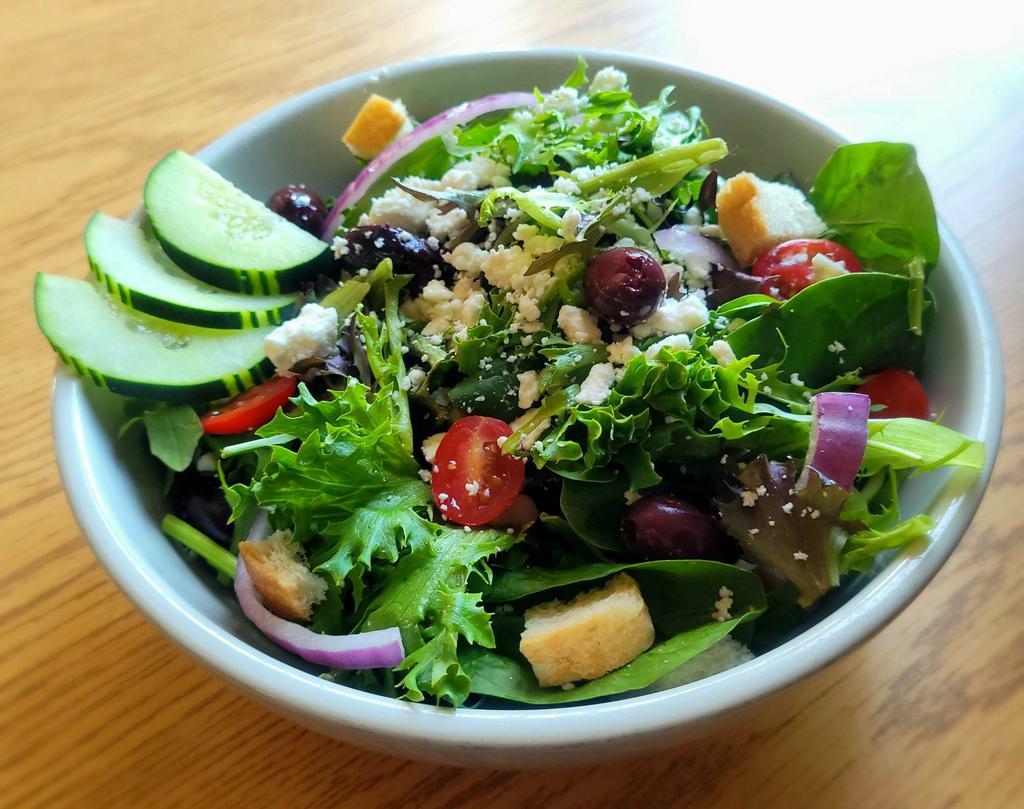 Greek Salad · Spring greens topped with fresh cucumber, tomato, Kalamata olives, feta cheese, and house-made croutons. Served with a side of vinaigrette dressing.