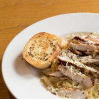 Fettuccine Alfredo with Chicken · Classic creamy Alfredo sauce, topped with Parmesan cheese. Served with a side of garlic bread.