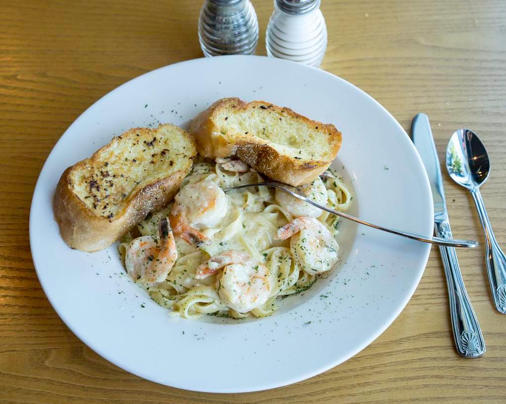 Prawn Fettuccine Alfredo · Large prawns sauteed with fresh garlic, finished in creamy Alfredo sauce, topped with Parmesan cheese. Served with a side of garlic bread.