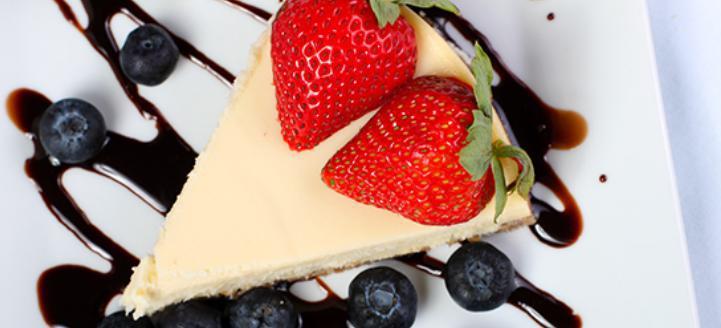 New York Style Cheesecake · Served with fresh fruit and whipped cream.