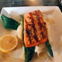 Salmon ala Roma · Grilled salmon in lemon butter wine sauce, served with grilled asparagus and mashed potatoes.