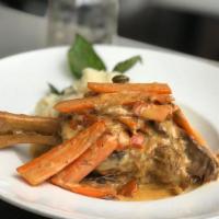 Lamb Shank · Oven baked lamb chunks in saffron sauce added with onions and carrots, served with mashed po...