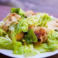 Caesar Salad · Crisp romaine tossed in garlic Caesar dressing topped with grilled chicken, croutons and sha...
