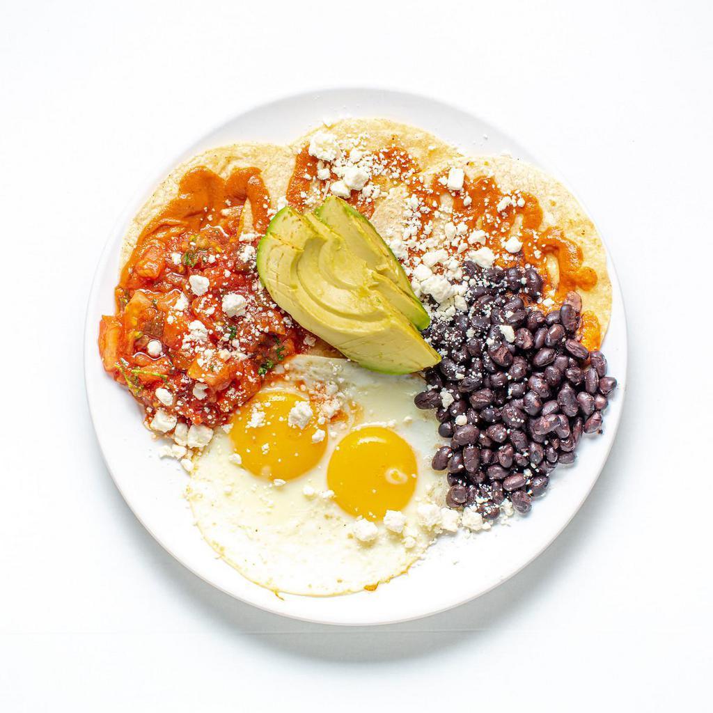Huevo Rancheros  · Two Eggs Any Style, In Housemade Pico De Gallo, Black Beans, In Housemade Ranchero Sauce Topped with Crumbled Feta Cheese and Avocado Wedges, Served Over Corn Tortillas