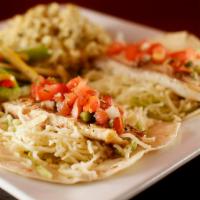 Fish Tacos (2 pc) · Flour tortillas filled with fish, roasted garlic sauce, lettuce, cheese, pico de gallo serve...