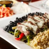 Fajitas · Grilled fresh marinated protein over mixed vegetables, served with flour tortillas, black be...
