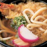 Udon Noodle Soup · Traditional Japanese udon noodle soup with bok choy, fish cake, fried tofu and tempura flake...