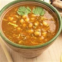 Moroccan Harira Soup · An amber-tinted soup with chickpeas, herbs and spices, in a flavorful tomato broth.