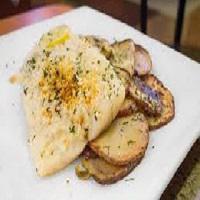 Baked Haddock · Flaky fish topped with breadcrumbs and a lemon garlic sauce, served with roasted potatoes.