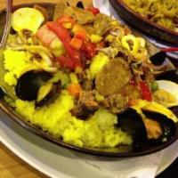 Paella Valenciana · Seafood paella with chicken and sausage.