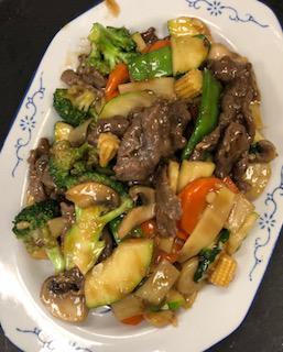 Beef Vegetable · Stir fried beef with zucchini, snow pea, mushroom, broccoli, water chestnut, baby corn, carrot, bamboo shoot in a garlic brown sauce.