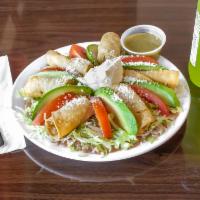 Taquitos Appetizer · Six rolled corn taquitos filled with chicken, beef, or pork. Served on beans, lettuce, avoca...
