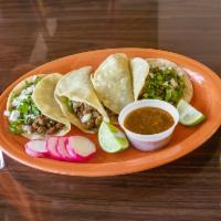 Tacos Al Albanil · 4 taco truck style tacos filled with chicken, beef, or carnitas, cilantro, and onions. Serve...