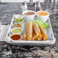FLAUTAS · SHREDDED CHICKEN AND CHEESE ROLLED IN A CORN TORTILLA THEN DEEP FRIED. SERVED WITH SIDE OF R...