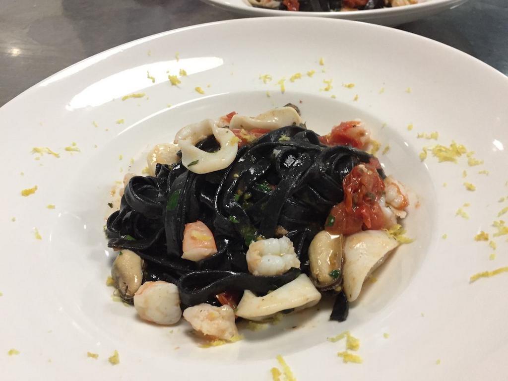Tagliolini neri ai Frutti di Mare · Homemade fresh squid ink  tagliolini- garlic - shrimp - sea scallops - clams - mussels - calamari- touch of tomato sauce