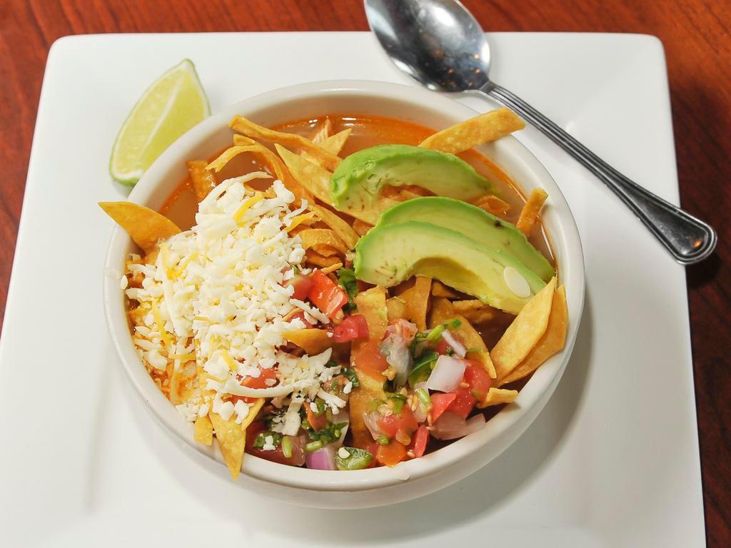 Tortilla Soup · Chicken broth with shredded chicken, rice, pico de gallo and cheese. Topped with tortilla chips and sliced avocado.