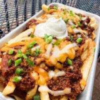 Chili Cheese Fries · French fries topped with mo’s kick’n 
chili, melted cheese, green onion, 
and sour cream