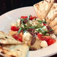 Hummus · Garbanzo beans blended to perfection with olive oil and topped with feta, basil, diced tomat...