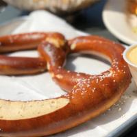 Soft Pretzel · A warm soft jumbo pretzel lightly salted and baked served with Mo’s Zesty 4-cheese sauce & h...