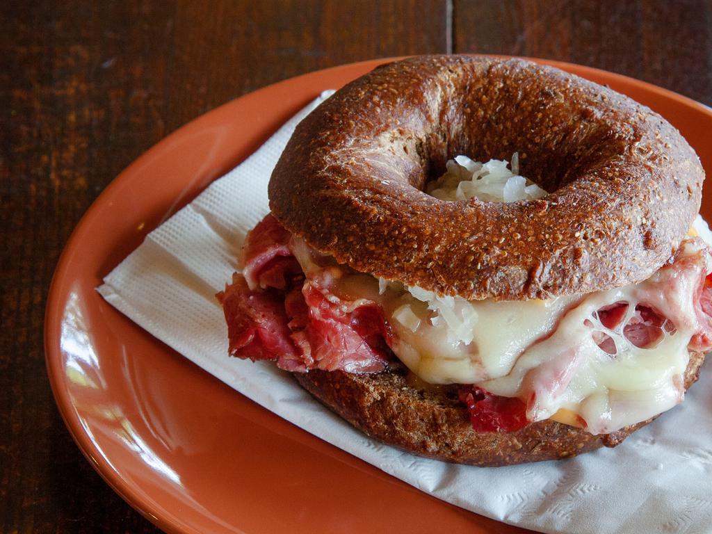 Reuben · You choice of bagel topped with our house corned beef, eastern european sour kraut (olykraut), swiss, and 1000 island dressing.
