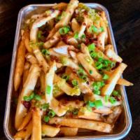 *LOADED FRIES · Thick cut fresh fries topped w/ house-made Ranch queso, chopped bacon, scallions & diced hou...
