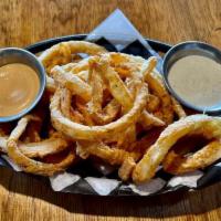 *HAND BATTERED THIN CUT ONION RINGS · Heaping serving of hand battered, thin-cut, deep fried onion rings
