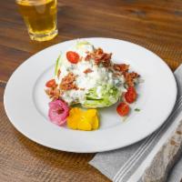 Wedge Salad  · Iceberg lettuce, Blue cheese, Crumbled bacon, Tomatoes.