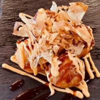 Takoyaki  · 4 pieces. Ball shaped dough with octopus pieces, corn, seaweed, sesame with okonomi sauce, s...