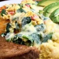 California Scramble · Onions, peppers, tomatoes and spinach, scrambled with eggs, over home fries, topped with Jac...