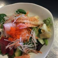 Sashimi Salad · Salad topped with sliced of tuna, salmon, yellow tail and shrimp.