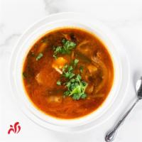 Tom Yum Gai · Spicy chili paste soup with chicken served with galangal, lime leaves, lemongrass, mushroom ...