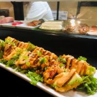 Avocado Bomb · Deep-fried: hand-dipped in panko bread, imitation crab, spicy tuna, Sriracha sauce, topped w...