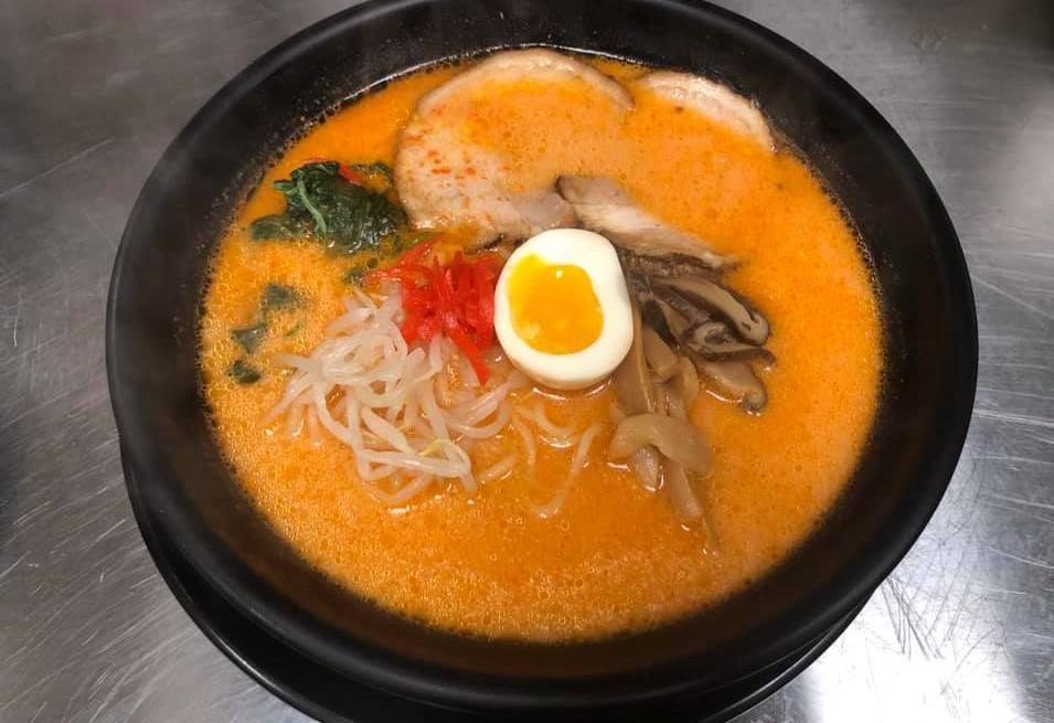 Miso Ramen · Ramen in a miso-based broth, topped with slices of roasted pork, bean sprout, spinach, shiitake mushroom, fish cake, nori and a soft boiled egg.