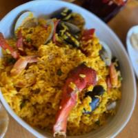 Paelha Marinheira · Lobster, shrimp, scallops, little neck clams, and mussels in a yellow rice casserole.
