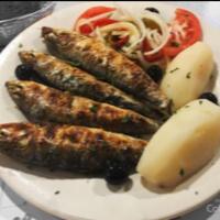 Sardinhas Assadas · Grilled whole sardines.